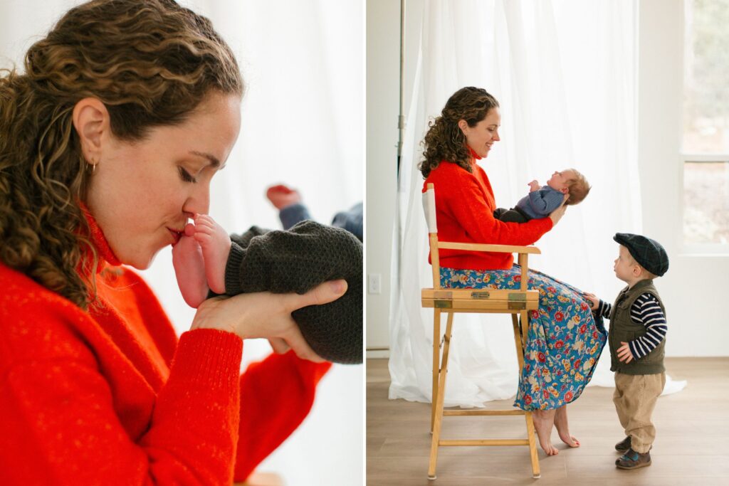 mom in a bright sweater kissing and tickling her newborn's toes and sitting with her toddler in a north idaho studio filled with light