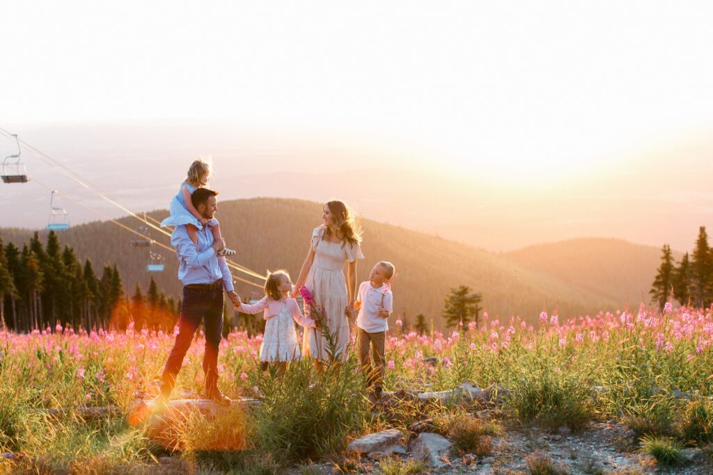 Family standing in a colorful wildflower field during family photography session