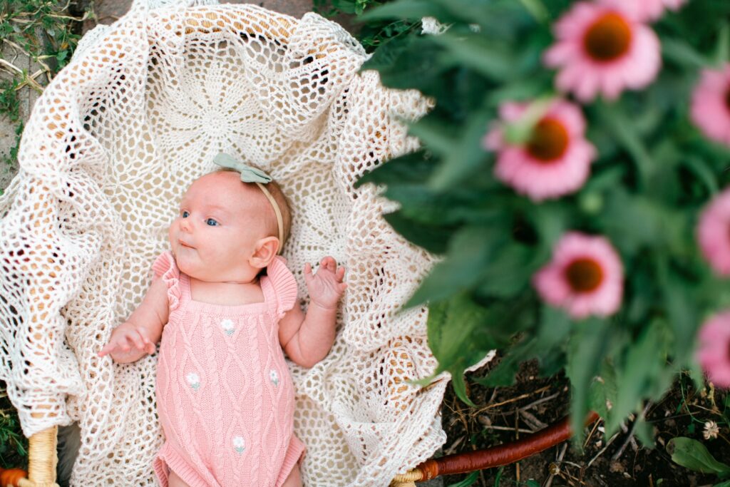 newborn laying in a blooming garden during a Post Falls family photography session