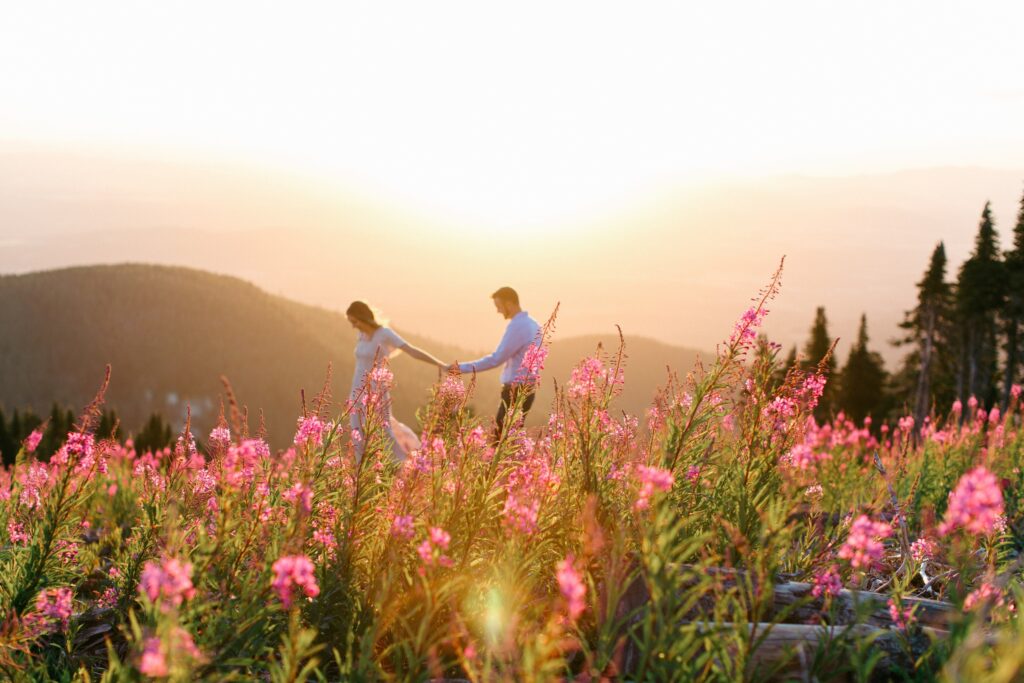 a couple exploring a wildflower field during a spring family session in Coeur d’Alene