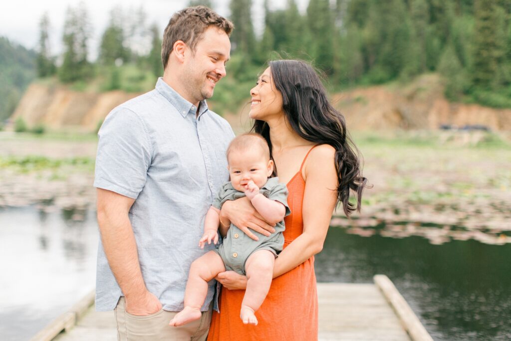 candid moment between parents and toddler near lake coeur dalene