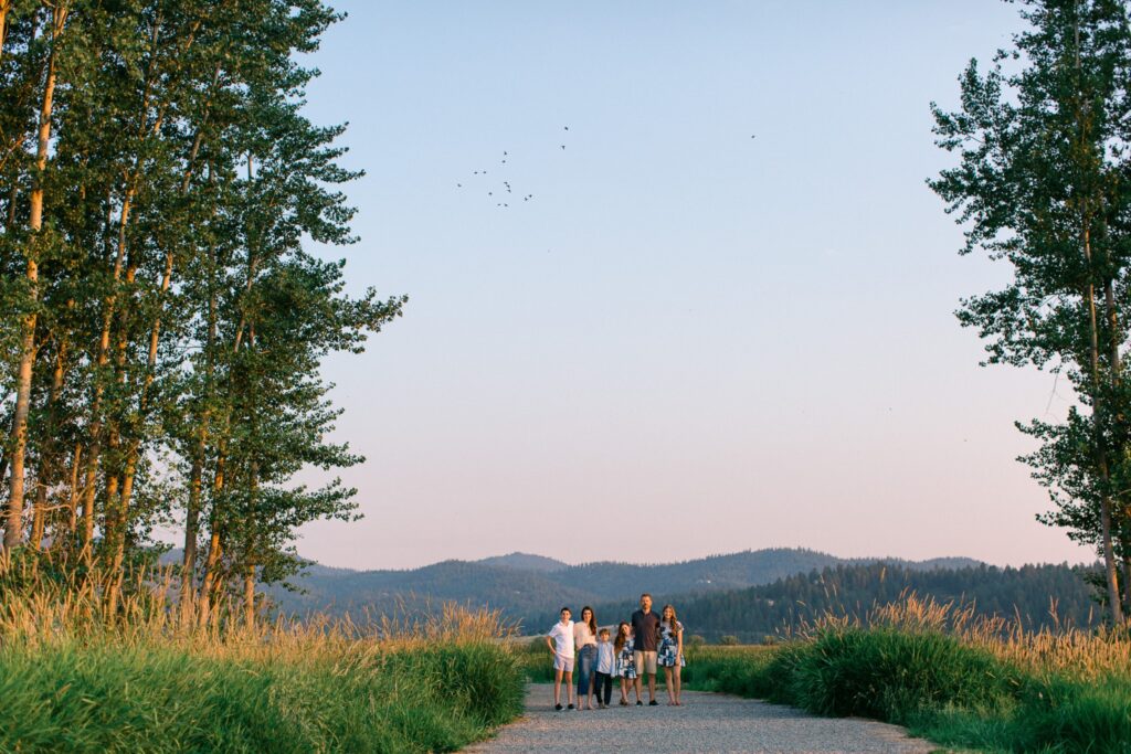 Outdoor family portraits in Liberty Lake wetlands at the saltese flats with mountain backdrop