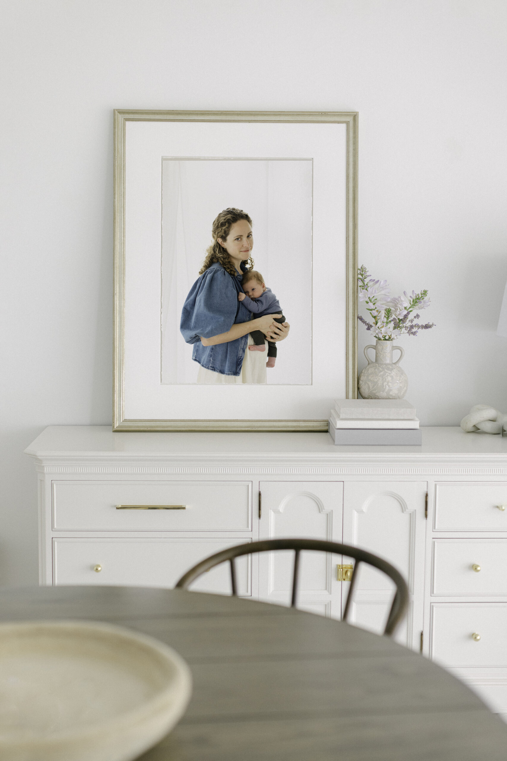 framed portrait of mother and newborn in coeurdalene idaho dining room