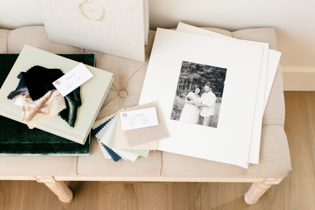 matted fine art print of first time parents with their newborn in coeur dalene idaho and other heirloom album samples