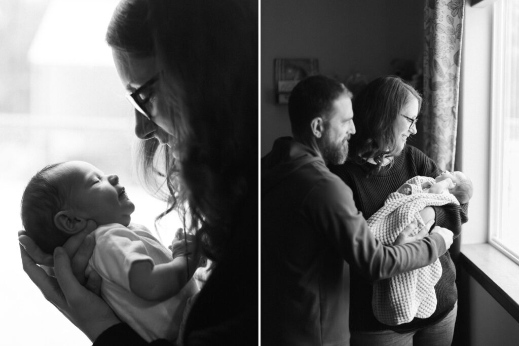 black and white portraits of mom and dad cuddling newborn baby in moody light in their nursery in spokane washington