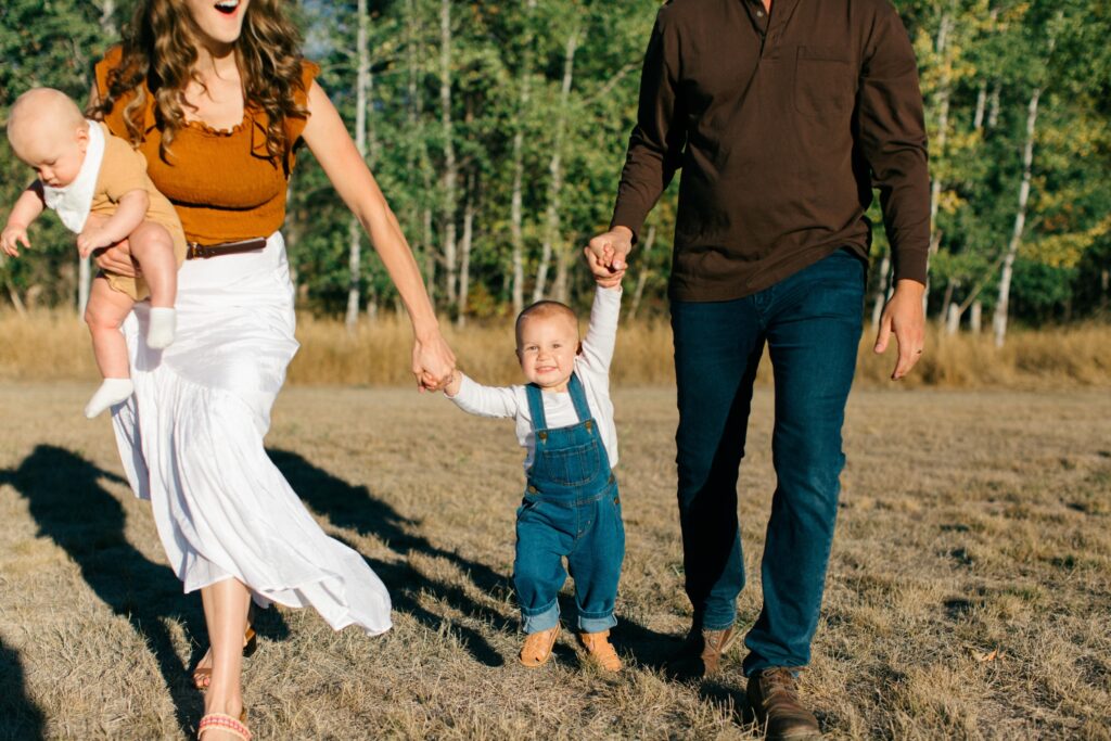 toddler smiling and playing during fall family photos
